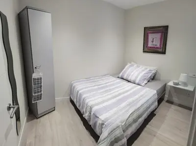 a small bedroom with a bed and a night stand at Barcelona, Apartamento de 2 habitaciones. in Hospitalet de Llobregat