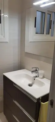 a bathroom with a white sink and a mirror at Barcelona, Apartamento de 2 habitaciones. in Hospitalet de Llobregat