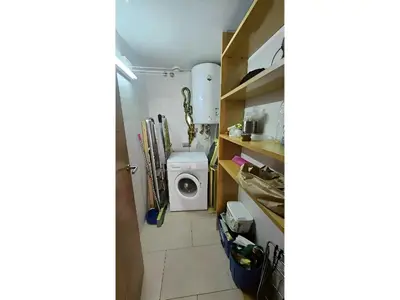 a laundry room with a washer and a washing machine at Apartament Calella in Calella
