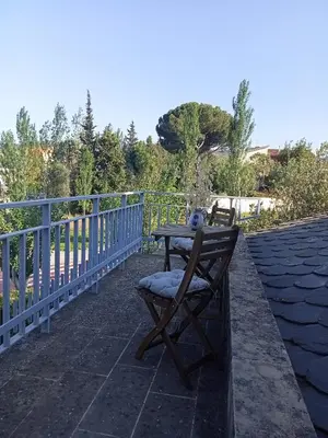 a table and a chair on a patio at Cal Kim in Martorell