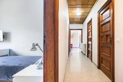 a hallway leading to a bedroom with a bed at Cal Kim in Martorell