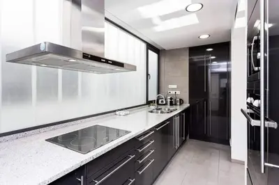 a large kitchen with a sink and a refrigerator at Modern Luxury Apartment Fira Bcn in Hospitalet de Llobregat