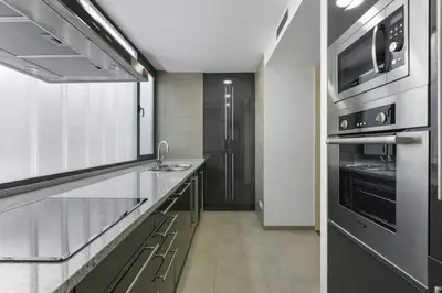 a kitchen with a sink and a stove at Modern Luxury Apartment Fira Bcn in Hospitalet de Llobregat