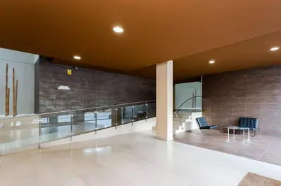 a lobby of a building with a staircase and a table at Modern Luxury Apartment Fira Bcn in Hospitalet de Llobregat