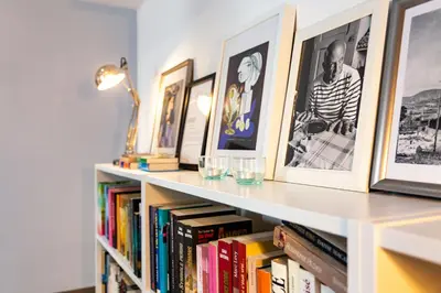 a book shelf with books and pictures on it at Stay U-nique Apartments Travessera II in Barcelona