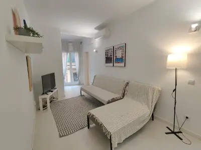 a living room with a couch and a tv at Family apartment close to Parc Güell in Barcelona