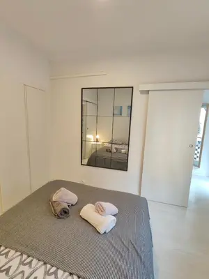 a bedroom with a bed with two towels on it at Family apartment close to Parc Güell in Barcelona