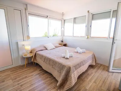 a bedroom with a bed with two towels on it at Elite Bonaire Penthouse by Hello Homes Sitges in Sitges