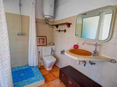 a bathroom with a sink and a toilet and a mirror at Elite Bonaire Penthouse by Hello Homes Sitges in Sitges