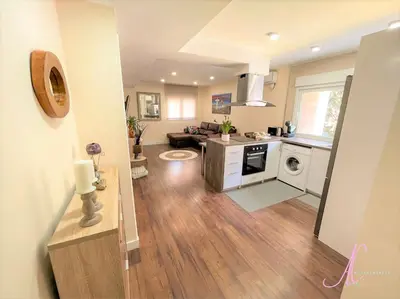 a kitchen and a living room with a kitchen and a living room at Arena Castelldefels in Castelldefels