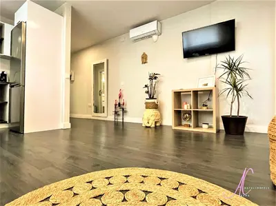 a living room with a flat screen tv on a wall at Arena Castelldefels in Castelldefels