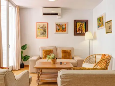 a living room with a couch and a table at Golden Sands by Hello Homes Sitges in Sitges