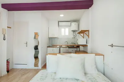 a small kitchen with white walls and a purple ceiling at SAGRADA FAMILIA APARTAMENT in Barcelona