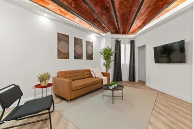 a living room with a couch and two tables at Tendency Apartments 5 in Barcelona