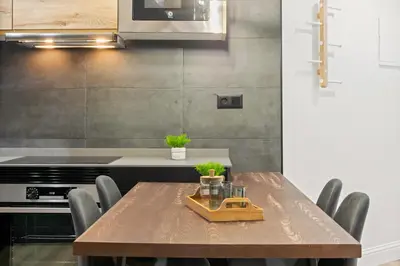 a kitchen with a wooden table and chairs at Tendency Apartments 5 in Barcelona