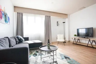 a living room with a couch and a tv at Tendency Apartments 5 in Barcelona