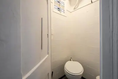 a white bathroom with a toilet and a window at CENTRIC APARTMENT GAUDI in Barcelona