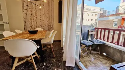 a dining room with a table and chairs on a balcony at Modern apartment close to the Camp Nou Stadium in Barcelona