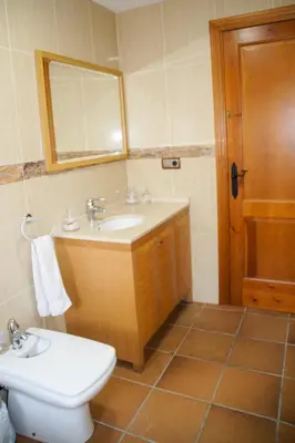 a bathroom with a sink and a toilet and a mirror at Casa Martina in Cardedeu