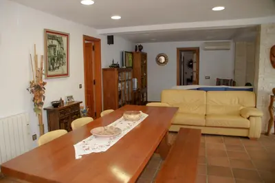 a living room with a table and a couch at Casa Martina in Cardedeu