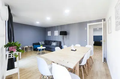 a dining room and living room with a table and chairs at Be Barcelona Plaza Catalunya in Barcelona
