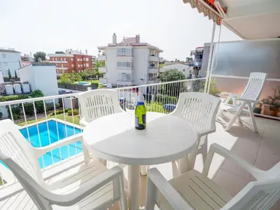 a white table and chairs on a balcony at Sitges with pool near beach by Hello Homes Sitges in Sitges