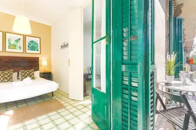 a living room with a bed and a table at Be Barcelona Eixample Universidad in Barcelona