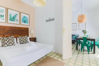 a white bedroom with a bed and a table at Be Barcelona Eixample Universidad in Barcelona