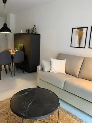a living room with a couch and a table at Topdown Apartments in Hospitalet de Llobregat