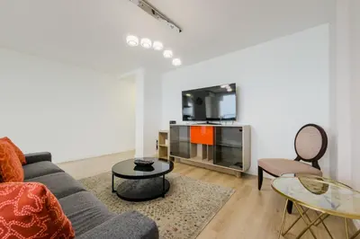 a living room with a couch and a tv at Impresionante Apartamento delante del Mar in Vilassar de Mar