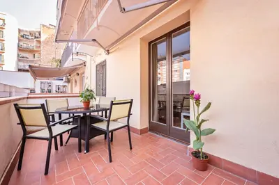 a patio with a table and chairs on a balcony at Sweett - La Villarroel in Barcelona