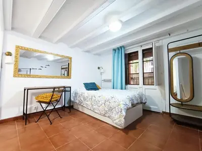 a bedroom with a bed and a mirror at COLORS FIRA GRAN VIA in Hospitalet de Llobregat