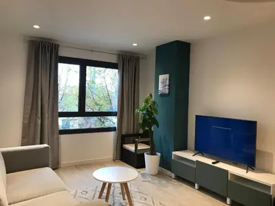 a living room with a large flat screen tv at Llull Home in Sant Adria de Besos