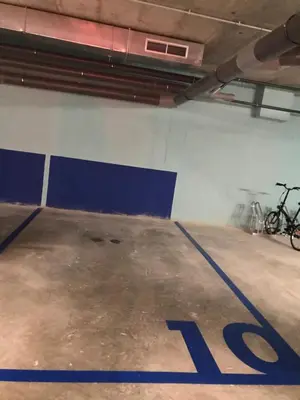 a parking lot with a bike parked in a garage at Llull Home in Sant Adria de Besos
