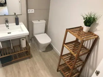 a bathroom with a white sink and a toilet at Llull Home in Sant Adria de Besos