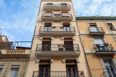 a tall building with balconies on a city street at ApartEasy - Turo Park with lovely balcony in Barcelona