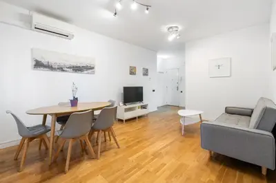 a living room with a table and chairs and a couch at Plaza Espanya Apartment in Barcelona
