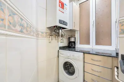 a laundry room with a washer and dryer at Plaza Espanya Apartment in Barcelona