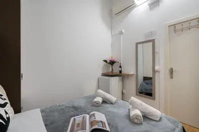a bed with a white towel on top of it at Hostal Sant Antoni in Barcelona