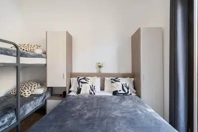 a room with a bed and a desk and a window at Hostal Sant Antoni in Barcelona