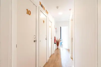 a room with two beds and a table with towels at Hostal Sant Antoni in Barcelona