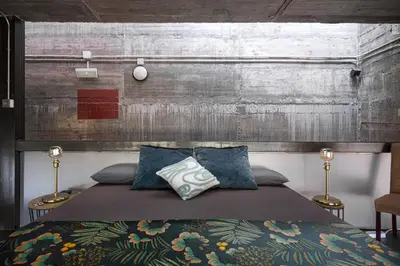 a bedroom with a large bed with blue pillows at THE LOFT - with private pool & jacuzzi in Corbera de Llobregat
