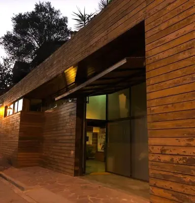 a brick building with a large glass entry door at THE LOFT - with private pool & jacuzzi in Corbera de Llobregat