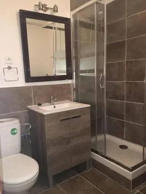 a bathroom with a shower and a toilet and a sink at Esquirol in Barcelona