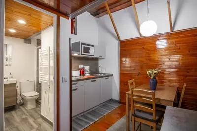 a kitchen and dining room with a table and a toilet at Gaudí Ramblas in Barcelona