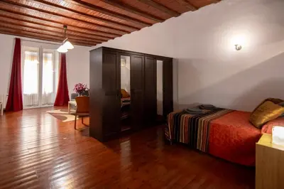 a bedroom with a bed and a living room at Gaudí Ramblas in Barcelona