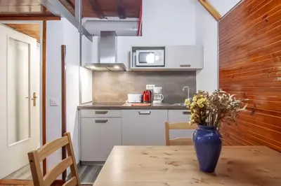 a kitchen with a table with a blue vase on it at Gaudí Ramblas in Barcelona