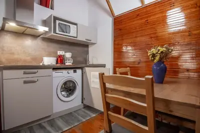 a kitchen with a table and a washing machine at Gaudí Ramblas in Barcelona