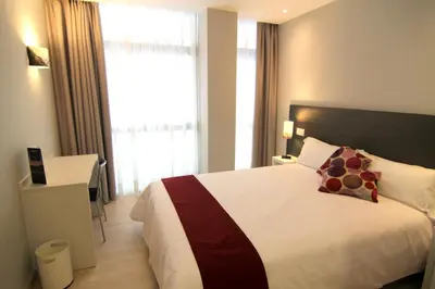 a bedroom with a large bed with a large window at Hostal Aslyp 114 in Barcelona