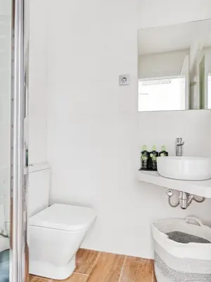 a white bathroom with a toilet and a sink at Limehome Barcelona Carrer de Fontcoberta - Digital Access in Barcelona